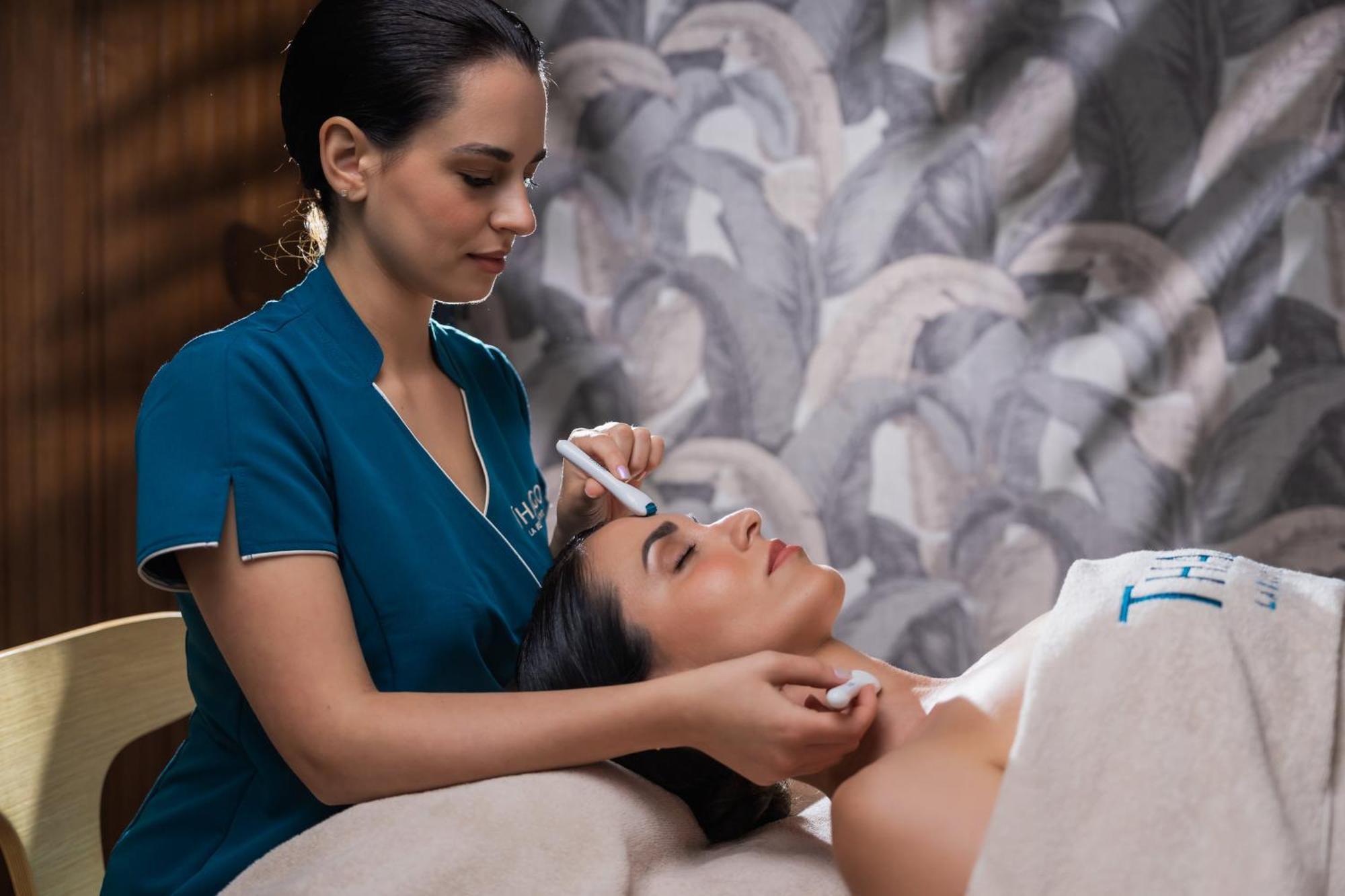 Hilton Rijeka Costabella Beach Resort And Spa Buitenkant foto A woman receiving a facial treatment